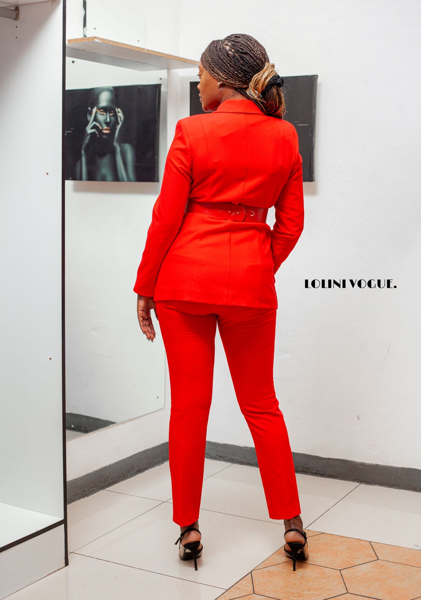 red ankle length pant suit with tailor fitted jacket that comes with a belt