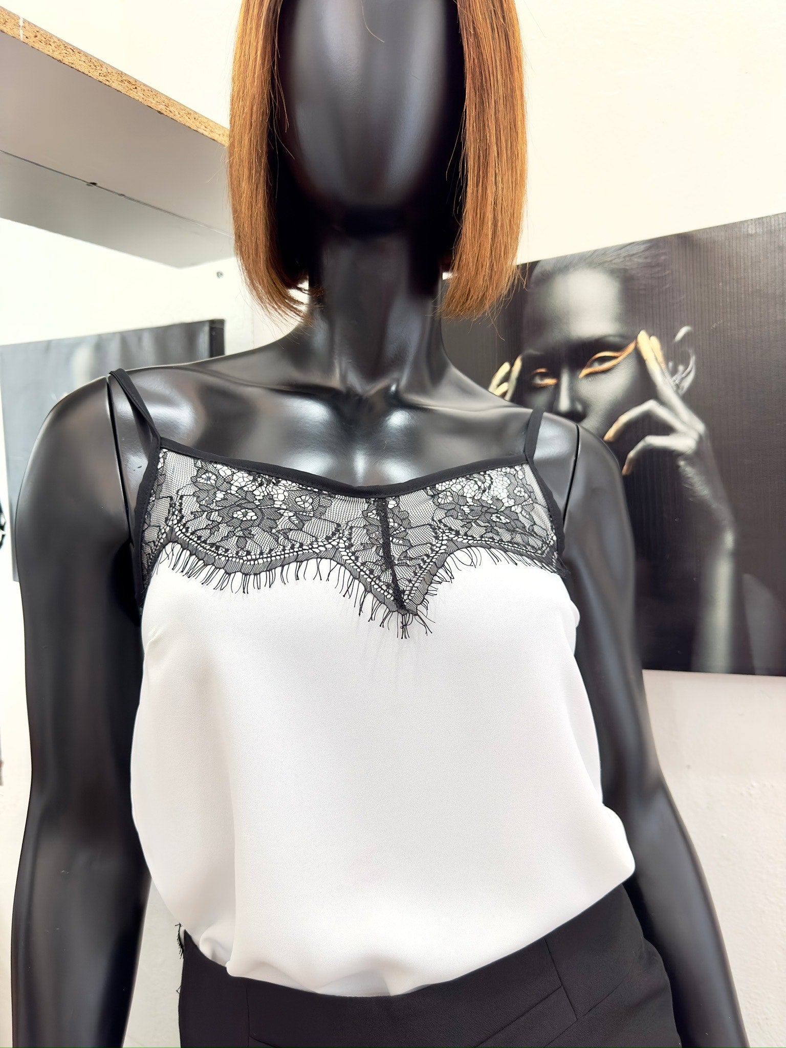 white cowl camisole with black lace